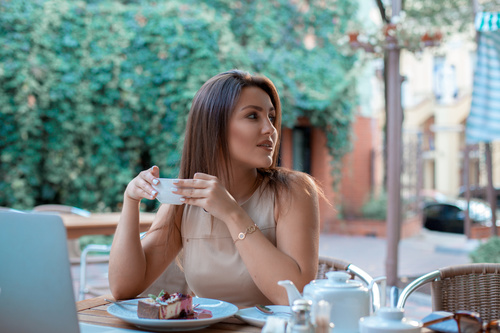 Girl looking back with a cup of coffee Stock Photo