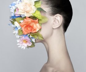 Girl wearing floral mask Stock Photo
