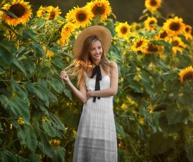 Girl wearing straw hat and sun flower Stock Photo