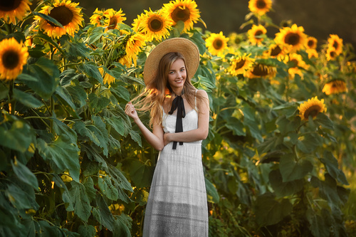 Girl wearing straw hat and sun flower Stock Photo