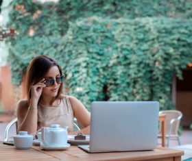 Girl wearing sunglasses in outdoor cafe Stock Photo