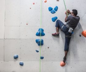 Indoor rock climbing fitness entertainment Stock Photo
