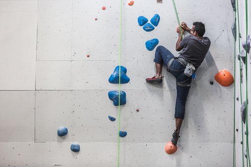 Indoor rock climbing fitness entertainment Stock Photo