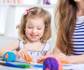 Little girl playing with plasticine Stock Photo