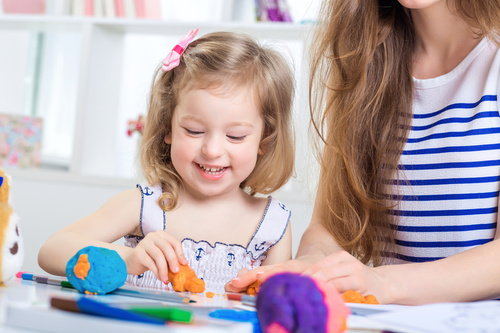 Little girl playing with plasticine Stock Photo