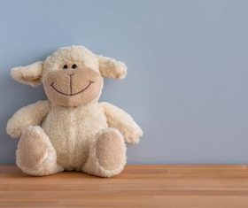 Plush teddy bear placed against wall Stock Photo