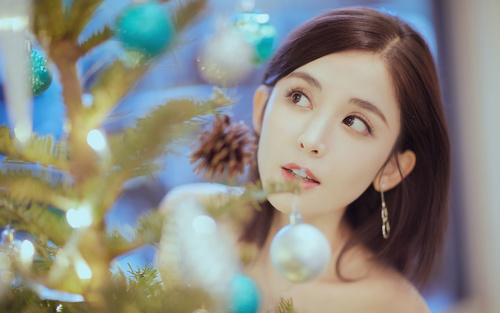 Pretty asian girl looking at christmas tree Stock Photo 02