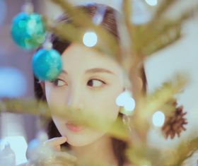 Pretty asian girl looking at christmas tree Stock Photo 03