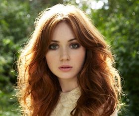 Red long haired beautiful woman looking at the front Stock Photo