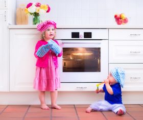 Sister and brother playing in the kitchen Stock Photo 04