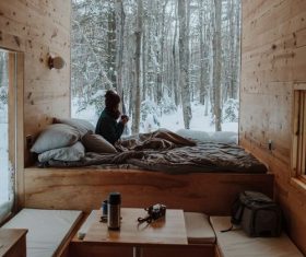 Sitting in the holiday house looking out the window of snow Stock Photo