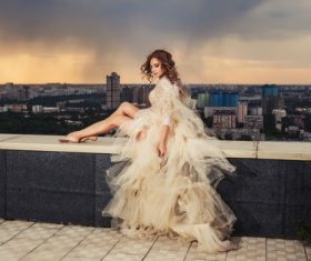 Sitting on the balcony of the roof photographing wedding woman Stock Photo