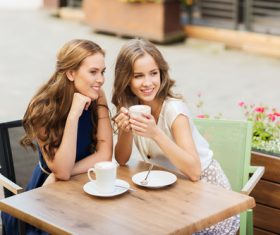 Stock Photo Woman chatting at outdoor cafe drinking coffee