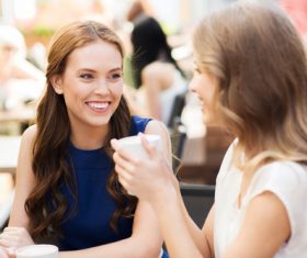 Stock Photo Woman drinking coffee chatting