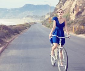 Stock Photo Woman riding a bicycle on the road