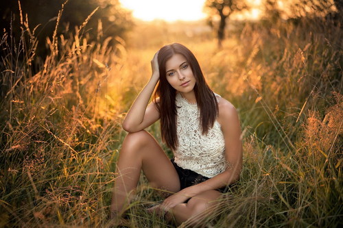 Stock Photo Woman sitting on the barren grass