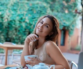 Stock Photo Young girl in outdoor cafe