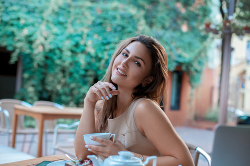Stock Photo Young girl in outdoor cafe