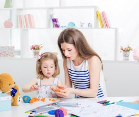 Stock Photo Young mother licks animal with plasticine
