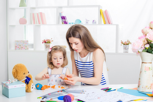 Stock Photo Young mother licks animal with plasticine