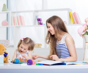 Stock Photo Young mother teasing daughter laughing