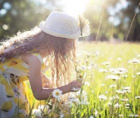The girl leaned over to smell the flowers Stock Photo