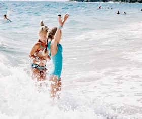 Two little girls playing in the sea Stock Photo