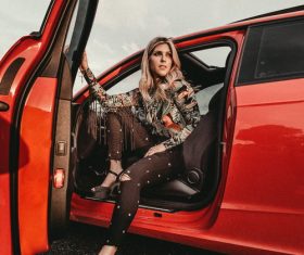 Woman opening the car door Stock Photo