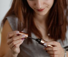 Woman painting eyeliner Stock Photo