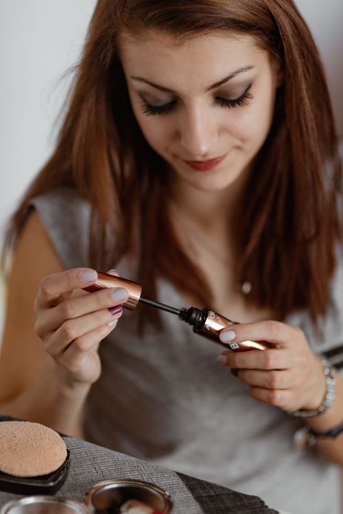 Woman painting eyeliner Stock Photo
