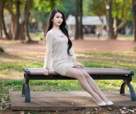 Woman posing on park bench Stock Photo