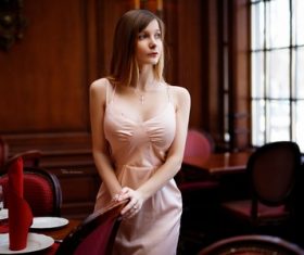 Woman standing in the restaurant looking away Stock Photo