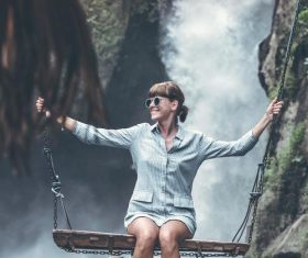 Woman swinging in scenic tourist area Stock Photo 02