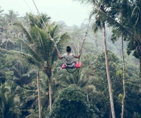 Woman swinging in scenic tourist area Stock Photo 04
