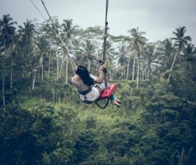Woman swinging in scenic tourist area Stock Photo 05