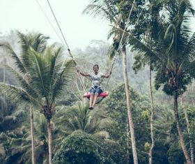 Woman swinging in scenic tourist area Stock Photo 06