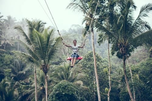 Woman swinging in scenic tourist area Stock Photo 06