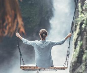 Woman swinging in scenic tourist area Stock Photo 07