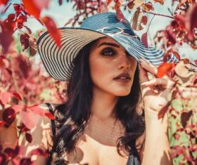 Woman wearing hat in maple woods Stock Photo