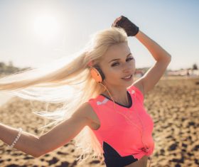 Woman with headphones is playing with hair Stock Photo