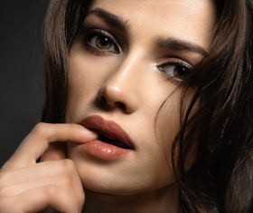 Womans face with finger on lips Stock Photo