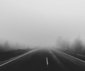a road covered with thick fog ahead Stock Photo