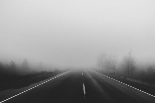 a road covered with thick fog ahead Stock Photo