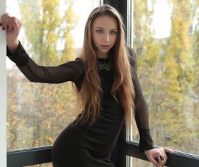 indoors black dress women Stock Photo