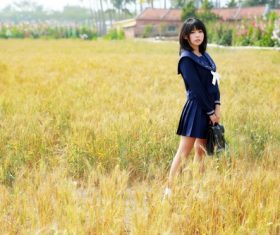 schoolgirl standing outdoors field Stock Photo