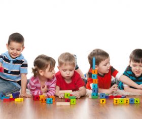 A group of children playing with building blocks Stock Photo