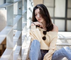 Asian woman sitting on the steps Stock Photo