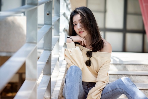 Asian woman sitting on the steps Stock Photo