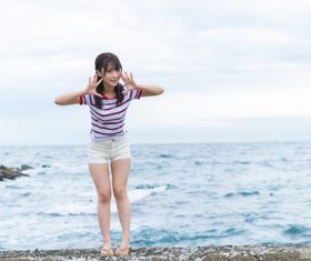 Cute Japanese girl by the sea Stock Photo