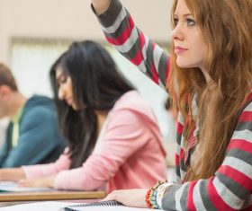 Female college student raising hand question Stock Photo